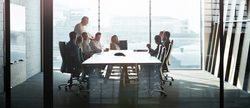 CEO giving peptalk to businesspeople at meeting in big conferenceroom